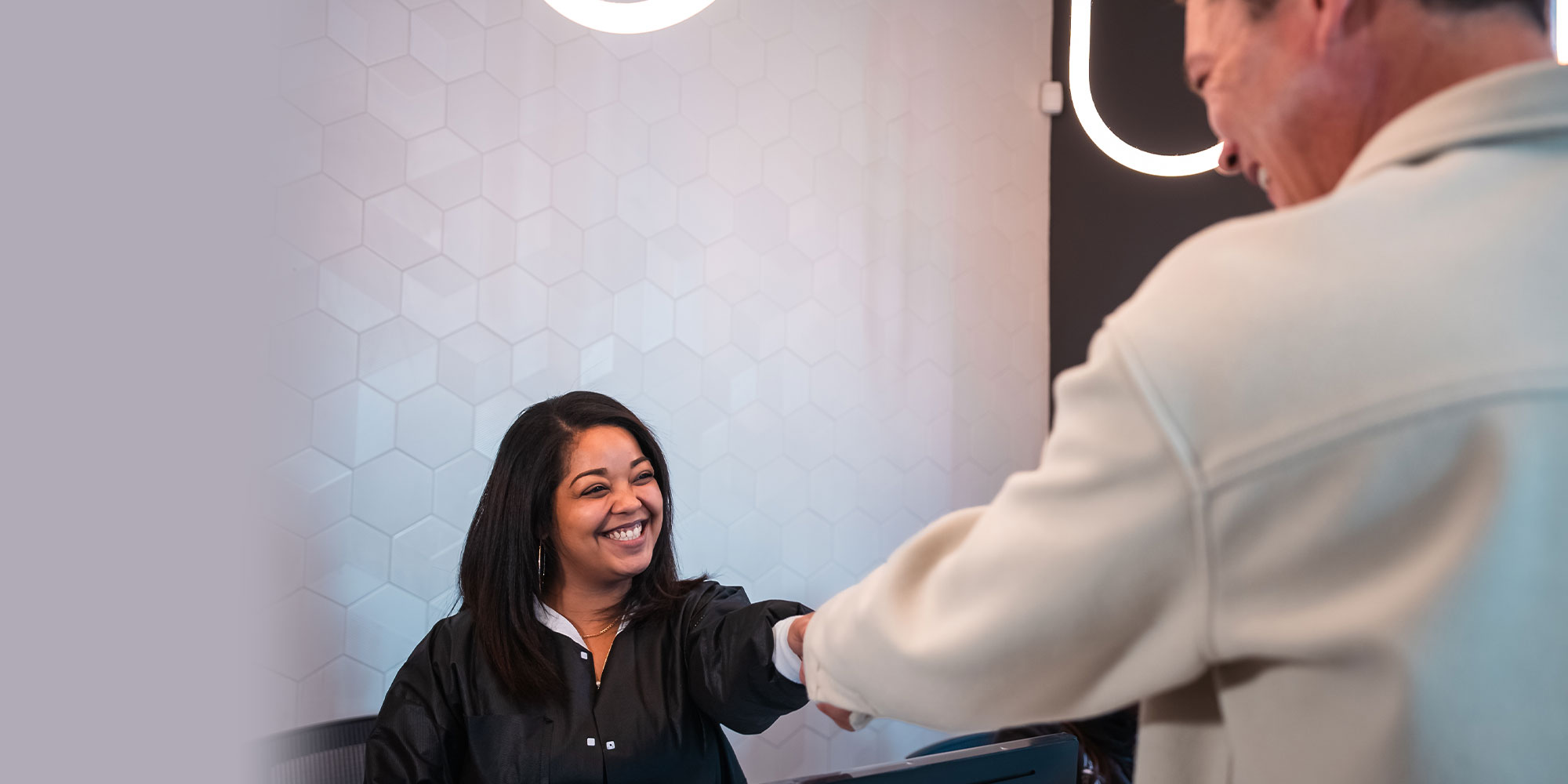 team member greeting someone into dental office
